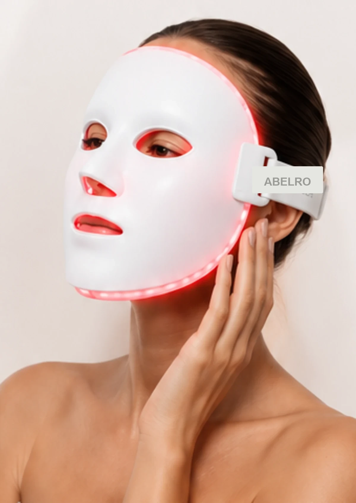 Woman wearing a red LED face mask